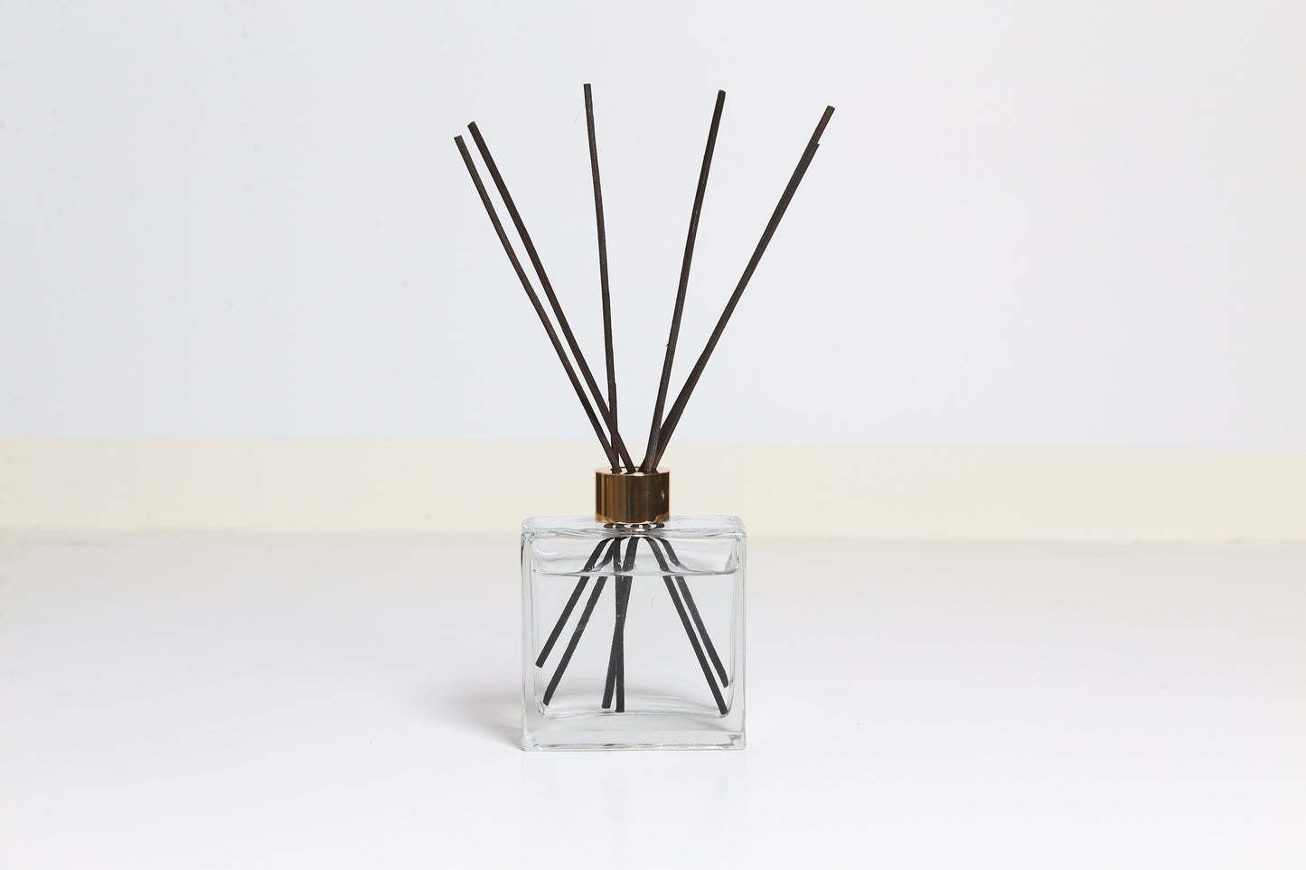 Black reed diffuser with white background