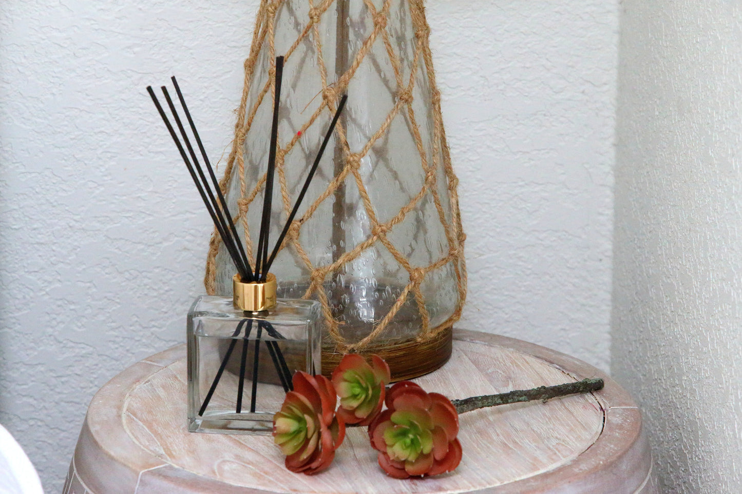 Black reed diffuser on bedside table