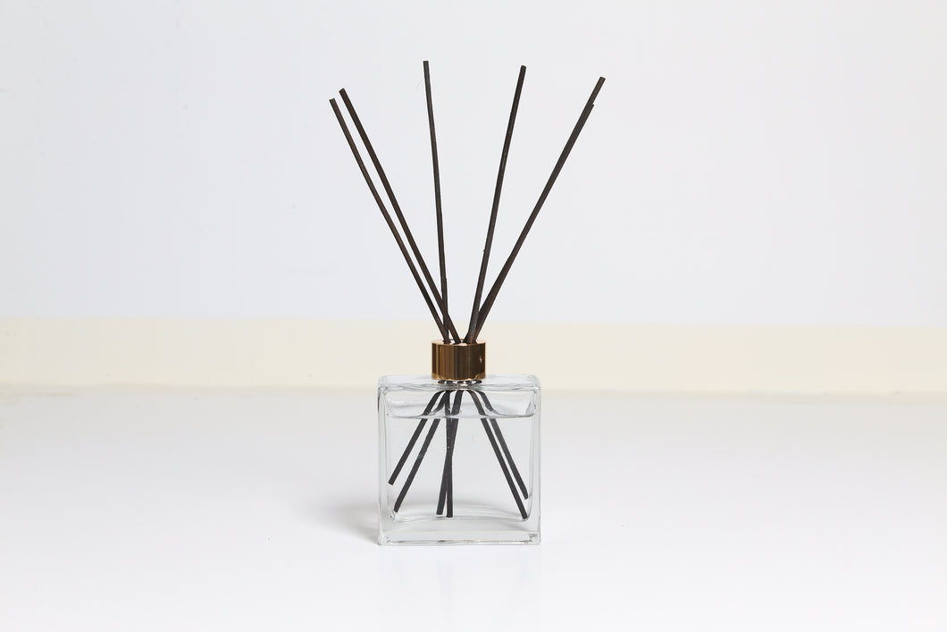 Black reed diffuser with white background