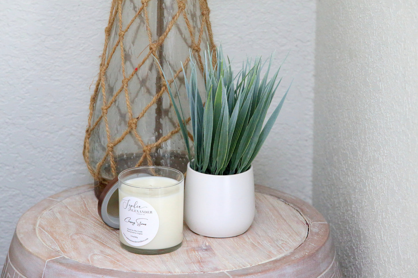 soy candle on nightstand with plant